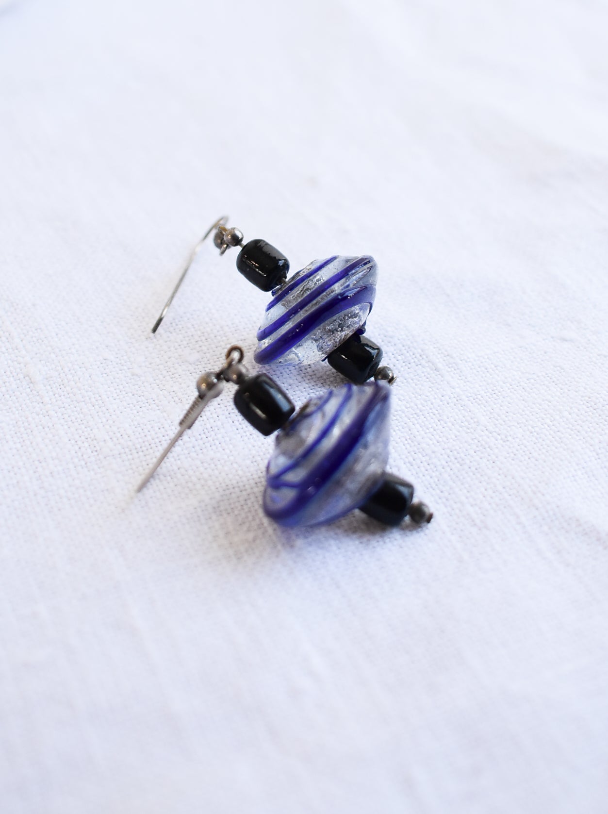 Blue and black glass swirly bead earrings